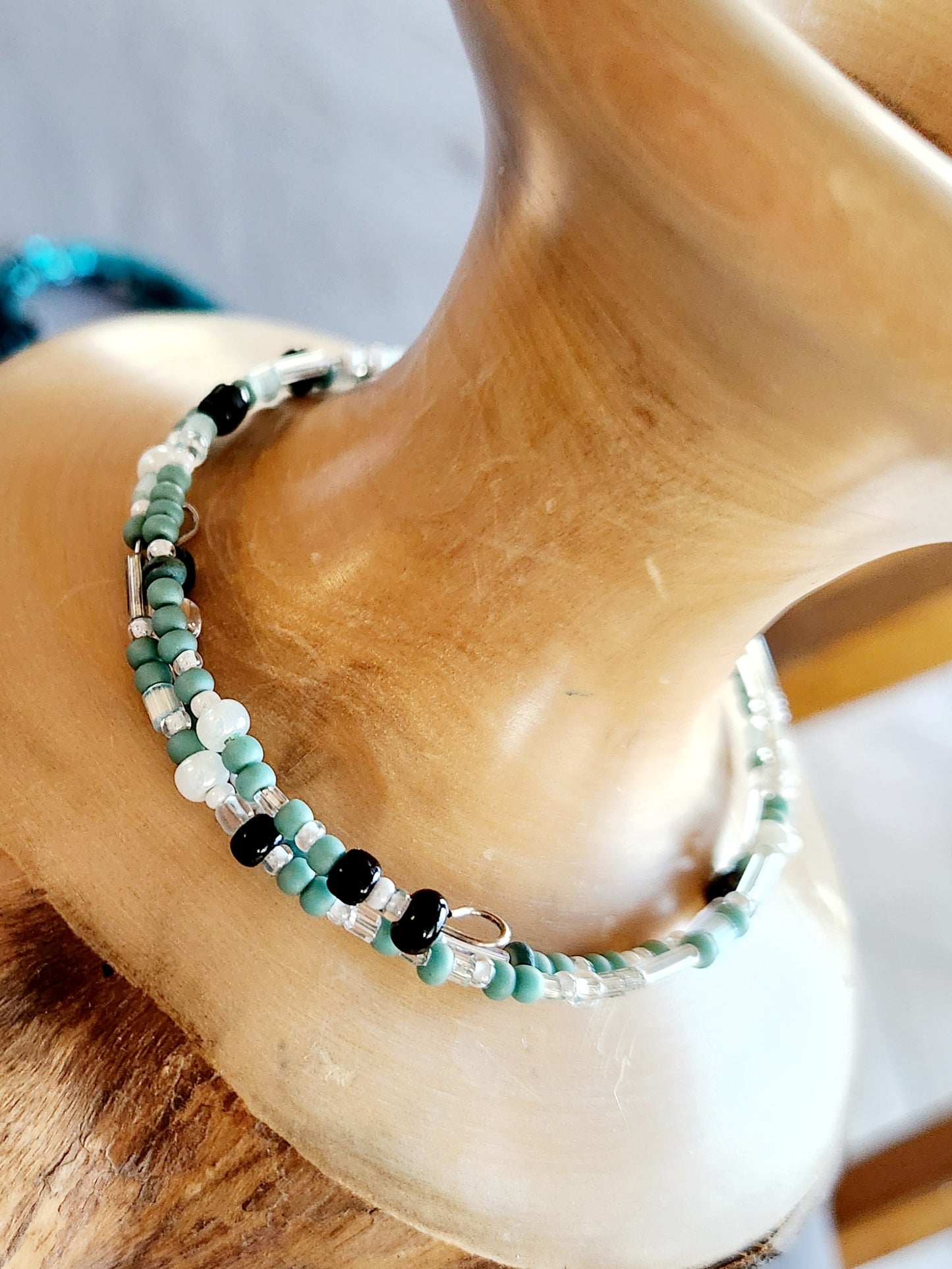 Bangle bracelet. Memory wire, beaded. Add-on charms available.