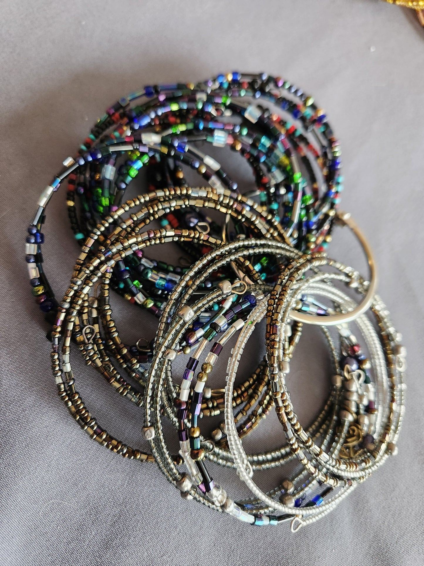 Bangle bracelet. Memory wire, beaded. Add-on charms available.